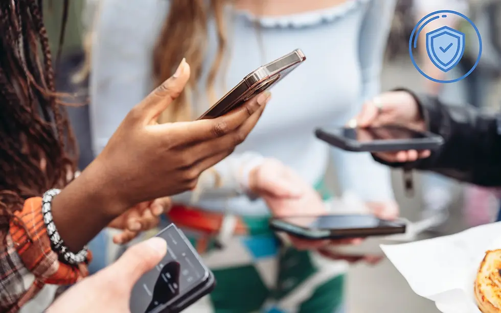 Group of young people holding smartphones, engaged in conversation, representing the constantly connected [to the internet] youth of today. Blue shield icon in the corner, suggesting security.