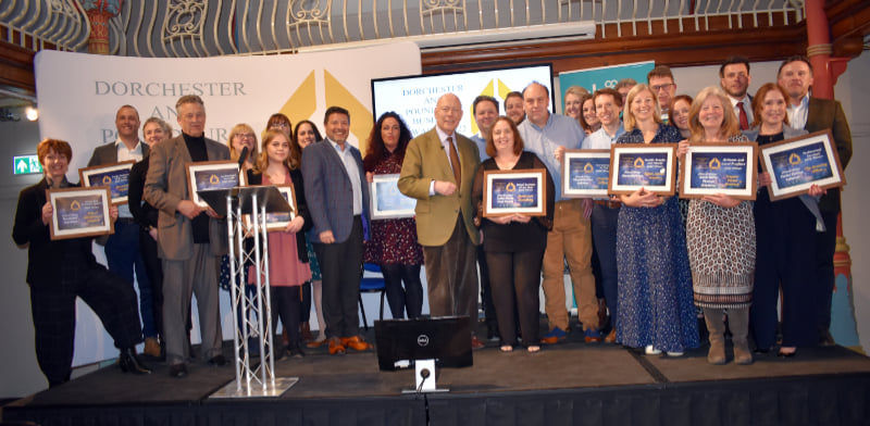 Award winners from Dorchester & Poundbury Business Awards 2022 stand proudly with their certificates